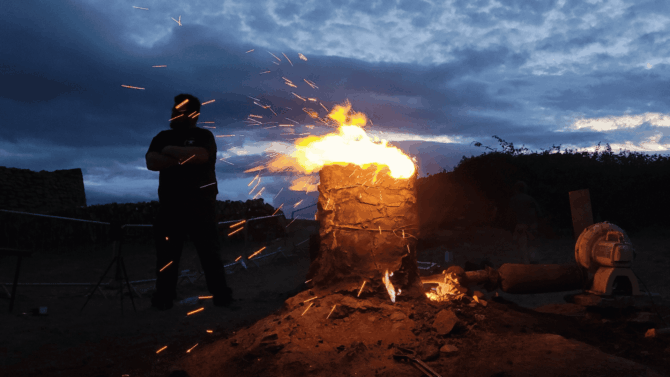Eoin beside furnace at night