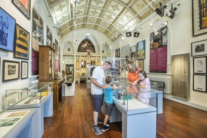 Family looking at the exhibition in Carlow Museum Copy