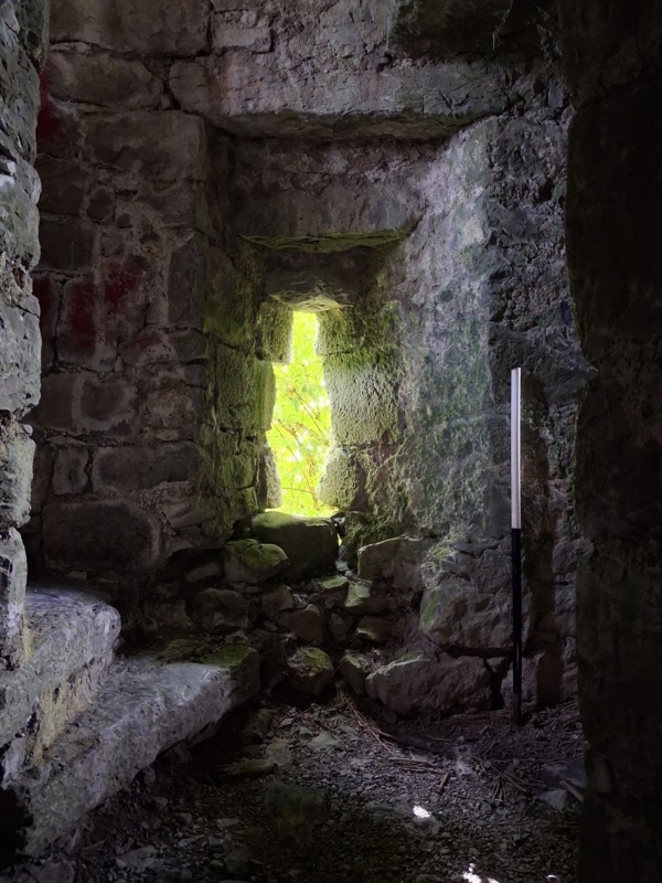 Light shines through the windows of Corofin Castle on the winding staircase and medieval masonry within Small Light shines through the windows of Corofin Castle on the winding staircase and medieval masonry within Small